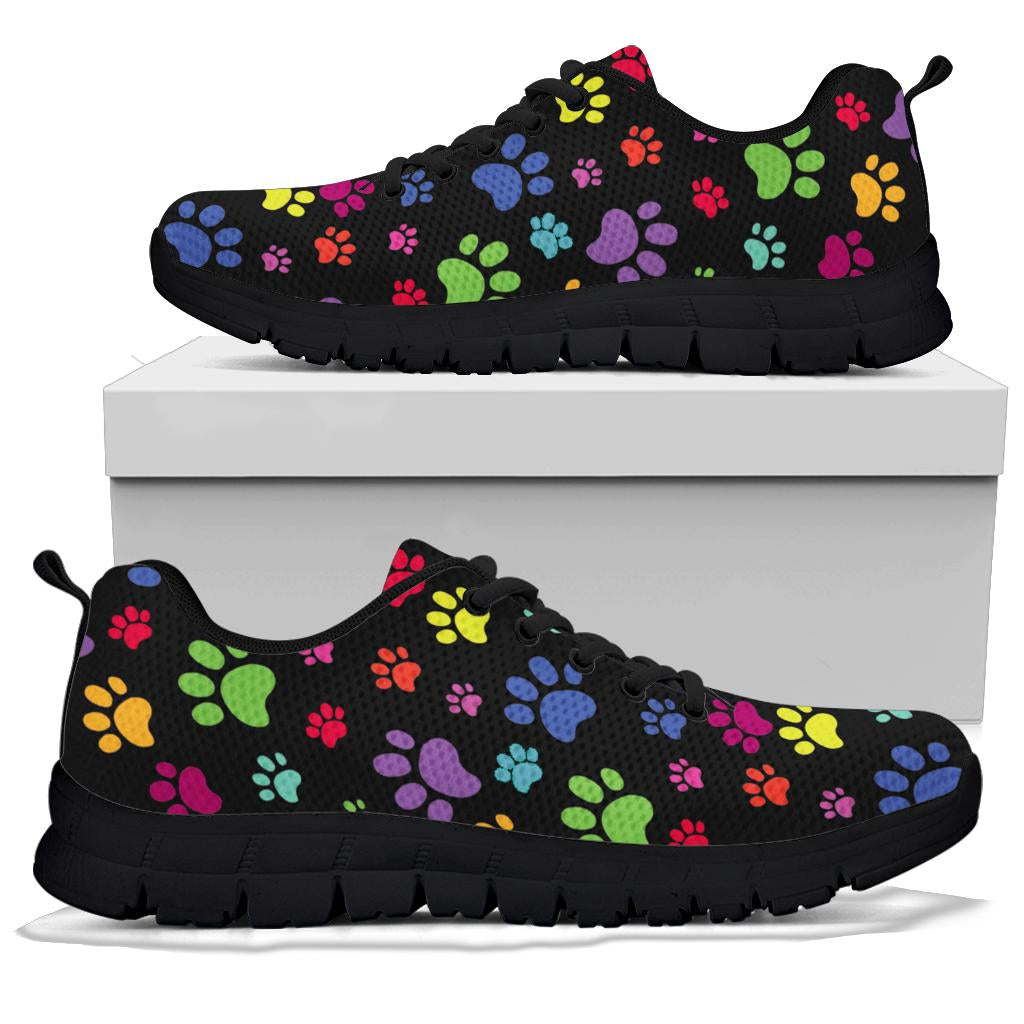 A pair of Colorful Paws Sneakers with black soles and black laces, displayed resting on top of a plain white shoe box.