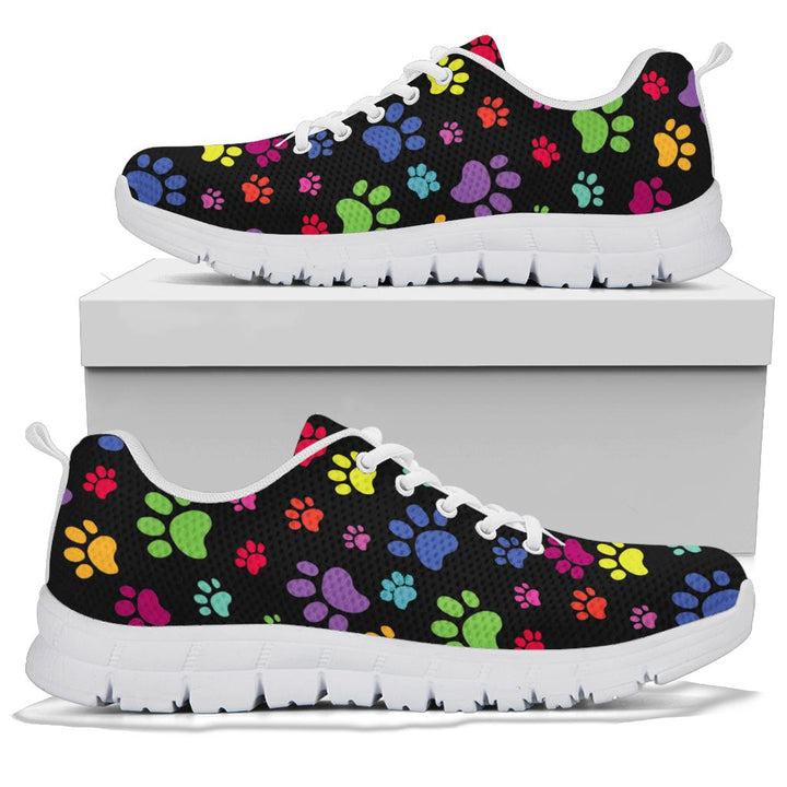 A pair of Colorful Paws Sneakers with white soles and white laces, displayed resting on top of a plain white shoe box.