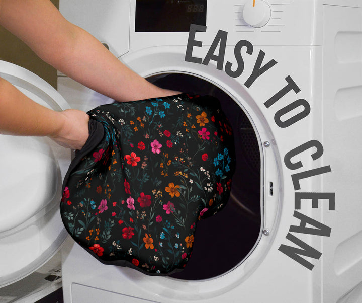 Floral Car Seat Cover being placed into a washing machine, highlighting that they are easy to clean.
