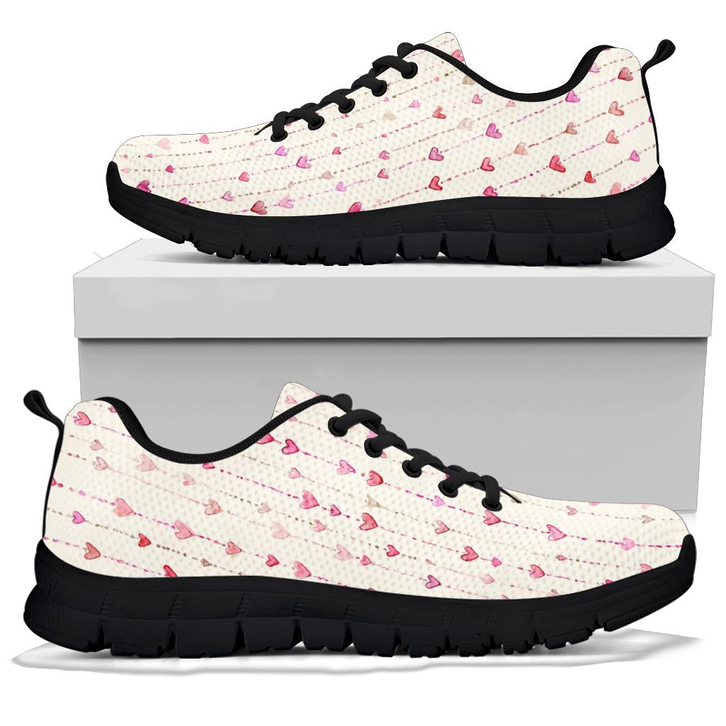 A pair of Hearts Sneakers with black soles and black laces, displayed resting on top of a plain white shoe box.