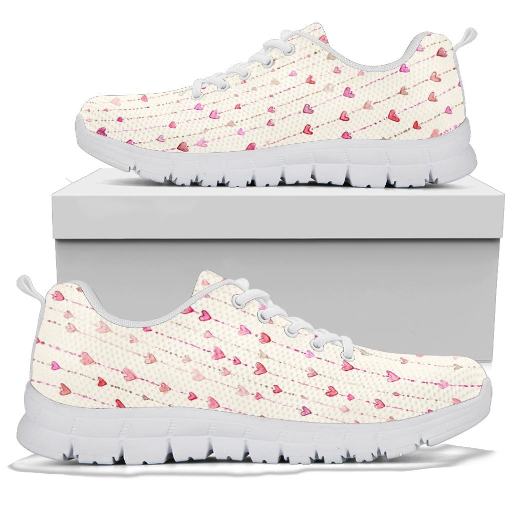 A pair of Hearts Sneakers with white soles and white laces, displayed resting on top of a plain white shoe box.