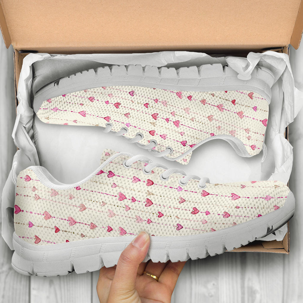 Unboxing Hearts Sneakers with white soles, showing the lovely patterned shoes inside a cardboard shoe box.