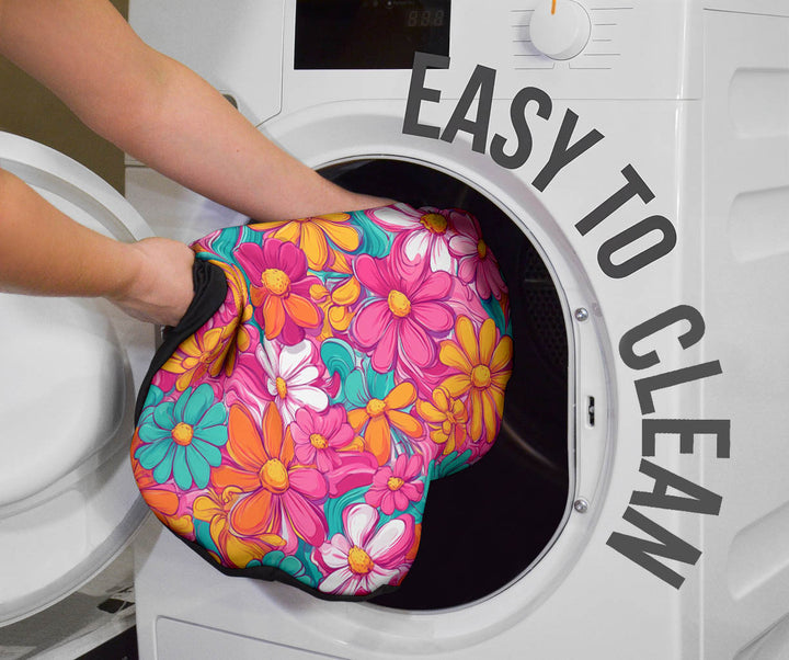 Hippie Floral Car Seat Cover being placed into a washing machine, highlighting that they are easy to clean.