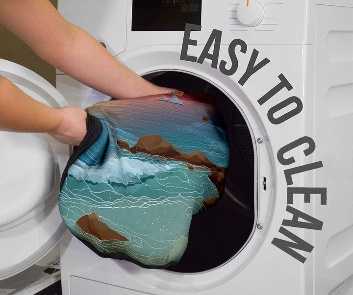 Magical Sunset Car Seat Cover being placed into a washing machine, highlighting that they are easy to clean.
