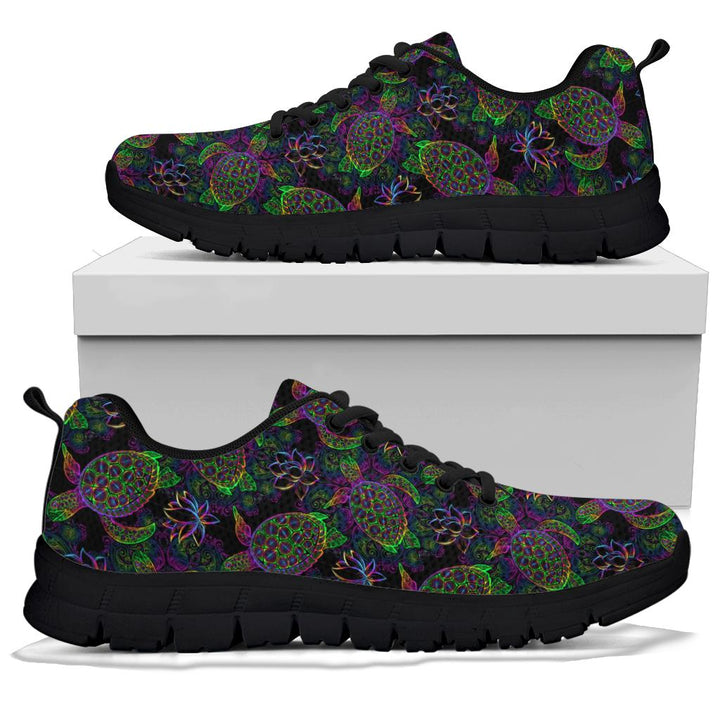 A pair of Sea Turtle Sneakers with black soles and black laces, displayed resting on top of a plain white shoe box.