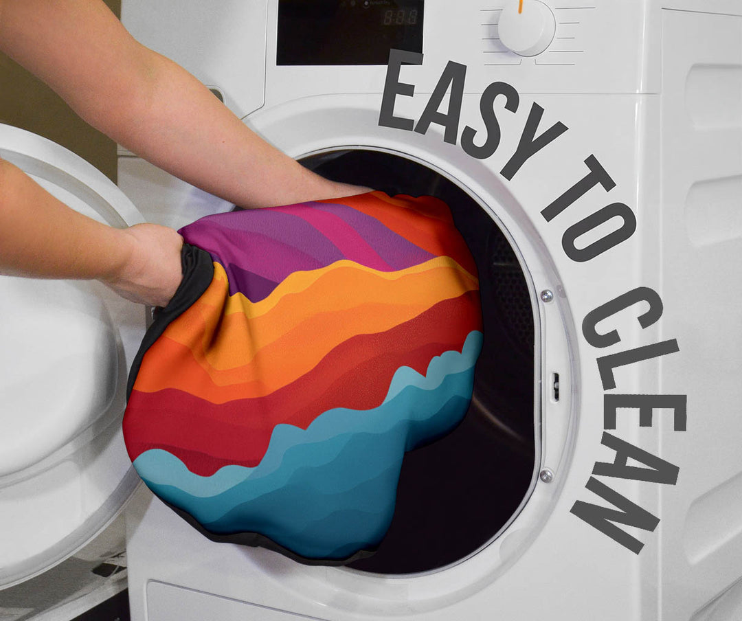 Sunrise Car Seat Cover being placed into a washing machine, highlighting that they are easy to clean.